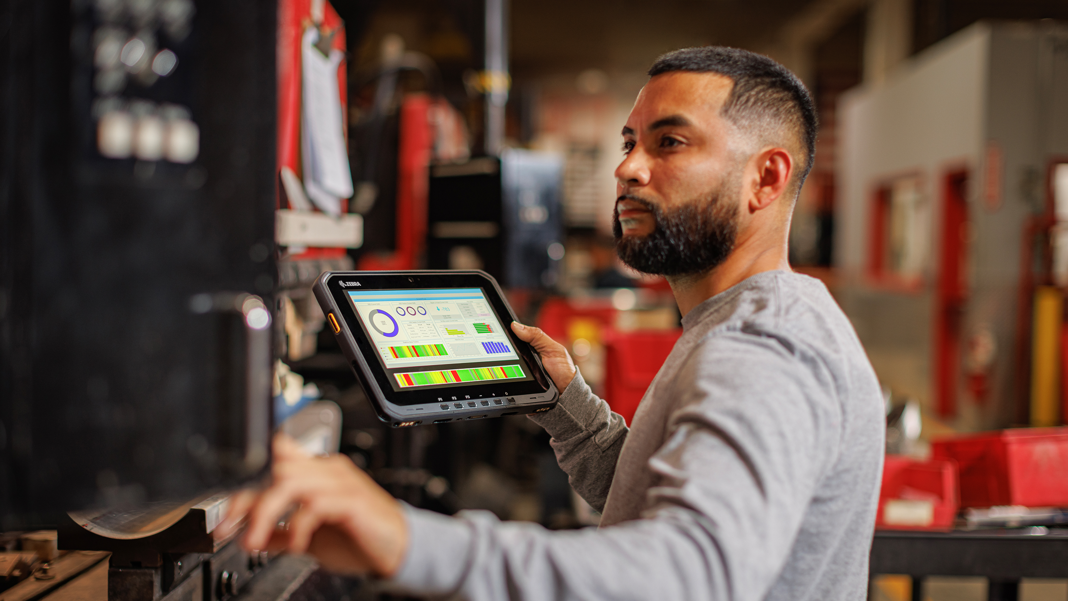 Handheld mobile computer displaying Device Guardian software among the Zebra logo morphism. 